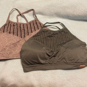 Gray and dark green sports bras cross straps. Size medium